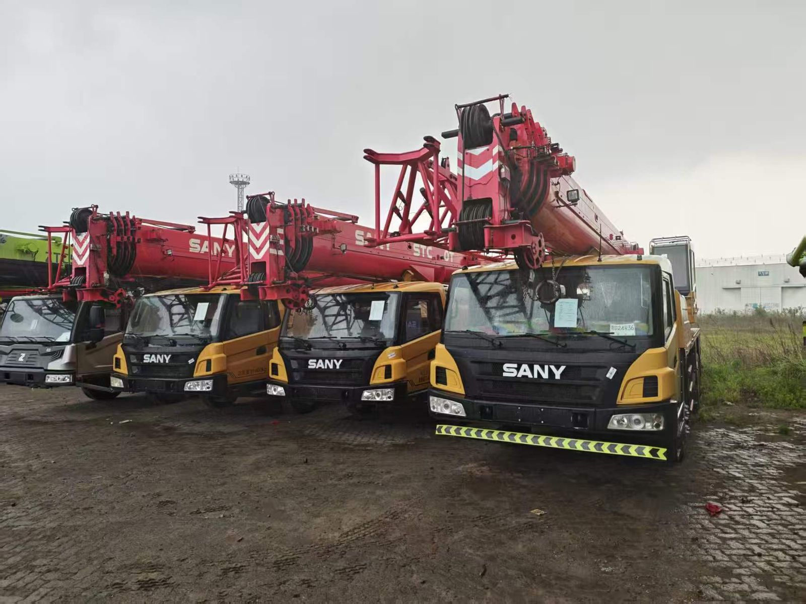 Mobile cranes and heavy trucks at an equipment yard in China